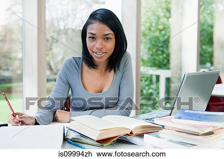 University student writing at desk, portrait View Large Photo Image Stock Image - University student writing at desk, portrait. Fotosearch