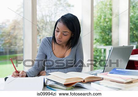 University student writing at desk View Large Photo Image Stock Image - University student writing at desk. Fotosearch