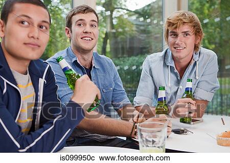 Stock Image - University students enjoying a beer in the college cafe. Fotosearch