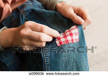 Woman repairing jeans, close up View Large Photo Image Stock Image - Woman repairing jeans, close up. Fotosearch