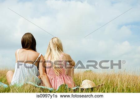 Young lesbian couple sitting together in countryside View Large Photo Image Stock Photograph - Young lesbian couple sitting together in countryside. Fotosearch