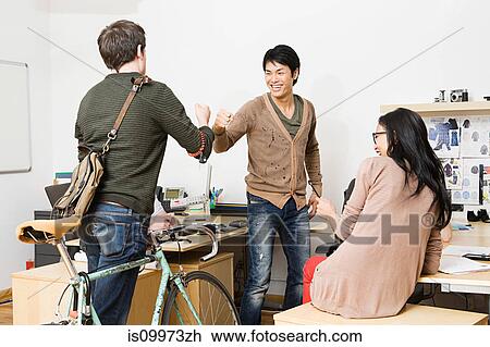 Young men and woman in office View Large Photo Image Stock Image - Young men and woman in office. Fotosearch