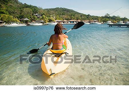 Young woman kayaking in sea View Large Photo Image Stock Photograph - Young woman kayaking in sea. Fotosearch