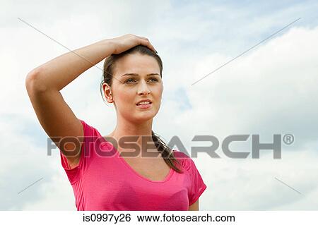 Young woman with hand on head View Large Photo Image Stock Photograph - Young woman with hand on head. Fotosearch
