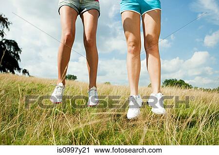 Young women jumping in a field View Large Photo Image Stock Image - Young women jumping in a field. Fotosearch