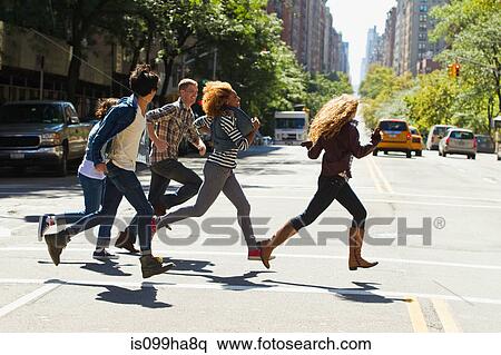 Five friends running through city street View Large Photo Image Stock Photography - Five friends running through city street. Fotosearch