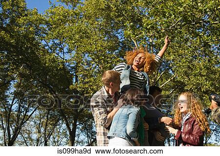 Group of friends cheering in park View Large Photo Image Stock Image - Group of friends cheering in park. Fotosearch