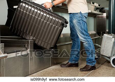 Man at check in desk of airport View Large Photo Image Stock Image - Man at check in desk of airport. Fotosearch