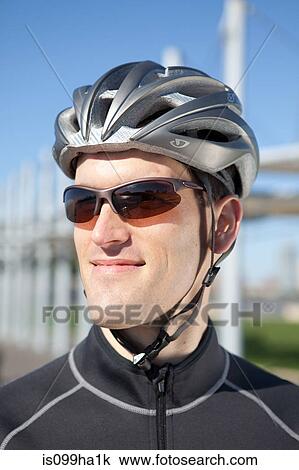 Stock Image - Man in cycling gear smiling confidently. Fotosearch