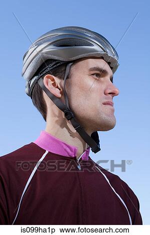 Man in cycling helmet looking into distance View Large Photo Image Stock Photography - Man in cycling helmet looking into distance. Fotosearch