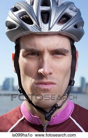 Picture - Man in cycling helmet looking straight ahead. Fotosearch
