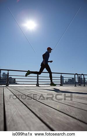 Man running across bridge View Large Photo Image Stock Photo - Man running across bridge. Fotosearch