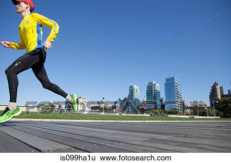 Stock Photograph - Man running on timber walkway. Fotosearch
