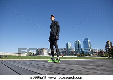 Stock Photograph - Man standing in running gear. Fotosearch