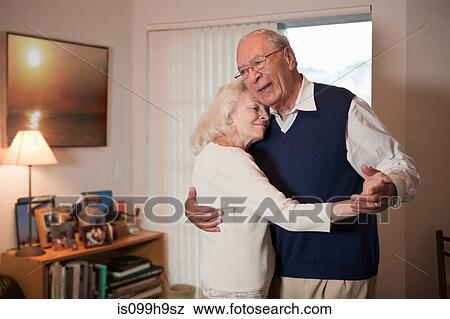 Senior couple dancing in living room View Large Photo Image Stock Photo - Senior couple dancing in living room. Fotosearch