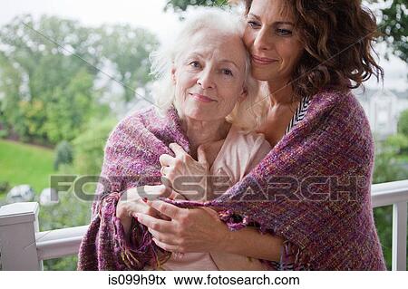 Senior woman and daughter embracing on porch, portrait View Large Photo Image Stock Photo - Senior woman and daughter embracing on porch, portrait. Fotosearch