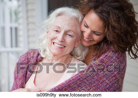 Senior woman and daughter embracing on porch, portrait View Large Photo Image Stock Photo - Senior woman and daughter embracing on porch, portrait. Fotosearch