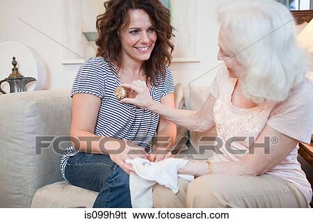 Senior woman giving daughter a brooch View Large Photo Image Stock Photograph - Senior woman giving daughter a brooch. Fotosearch