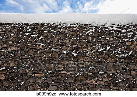 Snow on top of stone wall View Large Photo Image Stock Image - Snow on top of stone wall. Fotosearch