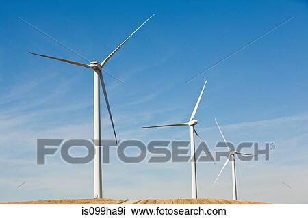 Stock Image - Three wind turbines side by side. Fotosearch