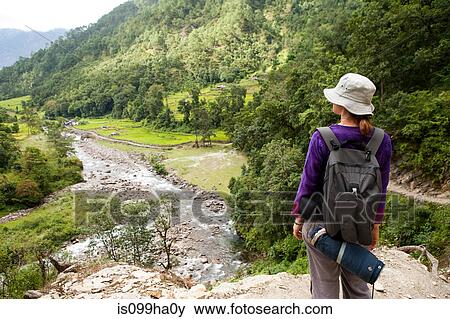 Tourist looking over valley, Nepal View Large Photo Image Stock Photo - Tourist looking over valley, Nepal. Fotosearch