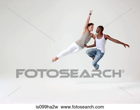 Stock Photo - Two young men in mid air. Fotosearch