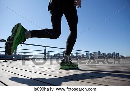 View of an athlete's legs running across walkway View Large Photo Image Stock Photo - View of an athlete's legs running across walkway. Fotosearch