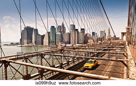 Stock Photo - Yellow taxi cab crossing Manhattan Bridge, Manhattan, New York, USA. Fotosearch