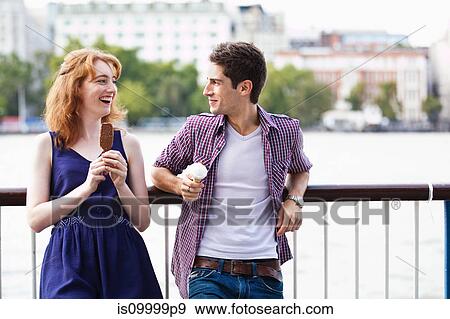 Young couple eating a lolly and an icecream View Large Photo Image Stock Photo - Young couple eating a lolly and an icecream. Fotosearch