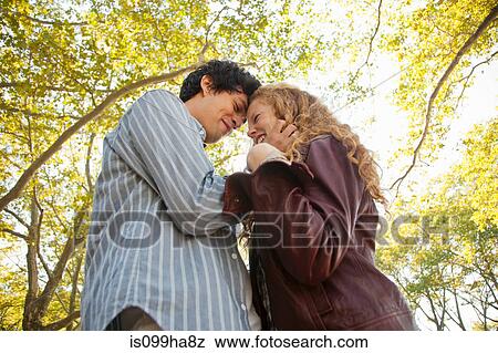 Young couple face to face in park View Large Photo Image Stock Photo - Young couple face to face in park. Fotosearch