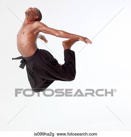 Stock Image - Young man in mid air. Fotosearch