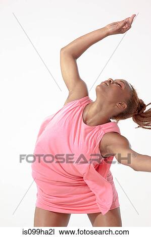 Young woman dancing as if in trance View Large Photo Image Stock Image - Young woman dancing as if in trance. Fotosearch