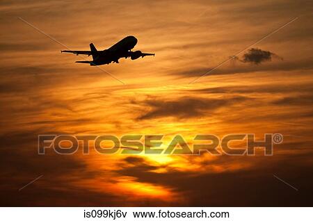 Airplane in in evening sky View Large Photo Image Stock Photo - Airplane in in evening sky. Fotosearch