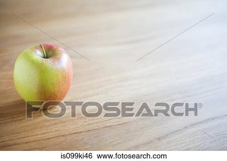 Apple on a table View Large Photo Image Stock Photograph - Apple on a table. Fotosearch