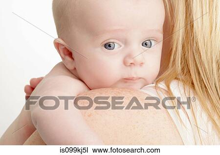 Baby boy on mother's shoulder View Large Photo Image Stock Image - Baby boy on mother's shoulder. Fotosearch