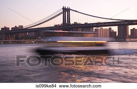Boat in motion on East River by Manhattan Bridge, New York City, USA View Large Photo Image Picture - Boat in motion on East River by Manhattan Bridge, New York City, USA. Fotosearch