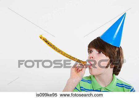 Stock Photography - Boy blowing party horn blower. Fotosearch