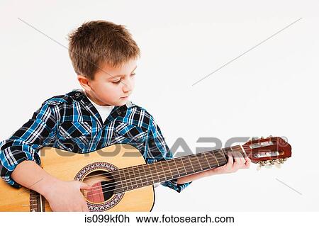 Boy playing guitar View Large Photo Image Stock Image - Boy playing guitar. Fotosearch