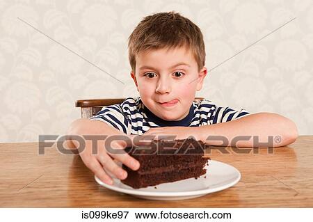Boy reaching for chocolate cake View Large Photo Image Stock Photo - Boy reaching for chocolate cake. Fotosearch