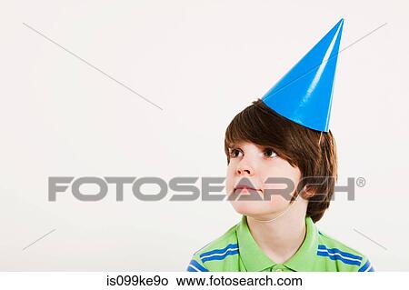 Boy wearing a party hat View Large Photo Image Picture - Boy wearing a party hat. Fotosearch