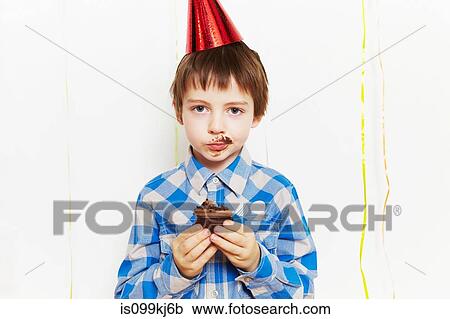 Boy with cupcake around his mouth View Large Photo Image Stock Image - Boy with cupcake around his mouth. Fotosearch