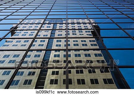Stock Image - Building reflected in glass skyscraper. Fotosearch