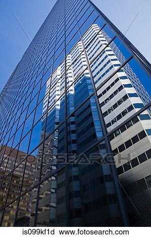 Stock Image - Building reflected in glass skyscraper. Fotosearch