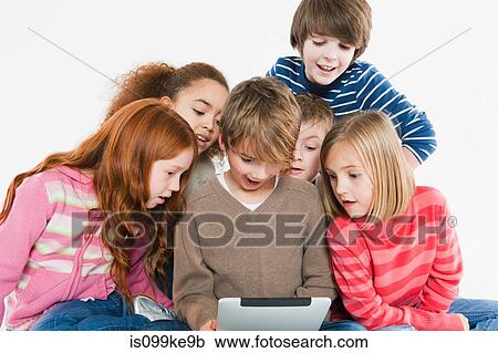 Children looking at digital tablet View Large Photo Image Stock Image - Children looking at digital tablet. Fotosearch