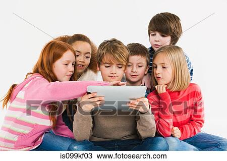 Children looking at digital tablet View Large Photo Image Stock Image - Children looking at digital tablet. Fotosearch