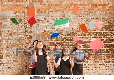 Children throwing books in the air View Large Photo Image Stock Photograph - Children throwing books in the air. Fotosearch