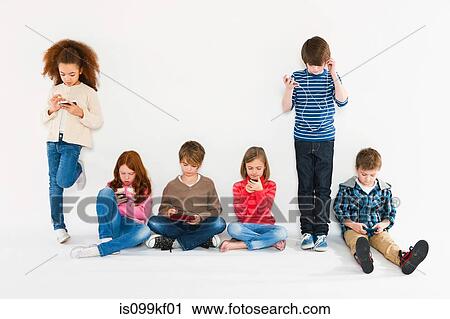 Stock Image - Children with different gadgets. Fotosearch