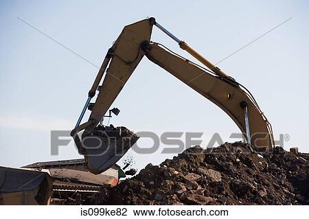 Earth mover and pile of rubble View Large Photo Image Stock Image - Earth mover and pile of rubble. Fotosearch