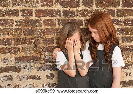 Girl comforting her friend View Large Photo Image Stock Photo - Girl comforting her friend. Fotosearch