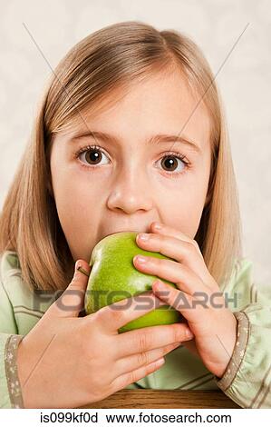Stock Image - Girl eating an apple. Fotosearch